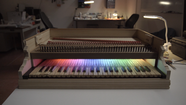 Figure 1: Electronically Augmented Keyboard Interface. Colour LEDs are hidden from visitors by the name plate. These LEDs were used in the development and calibration process for visual feedback of key states.